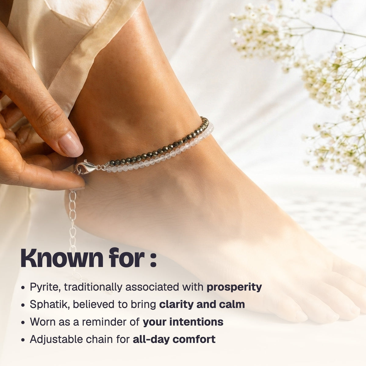 Woman fastening the pyrite and quartz anklet with its lobster clasp
