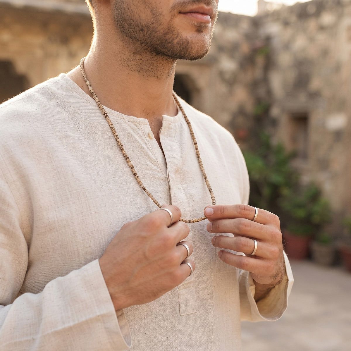 Man holding the Tulsi Kanthi Mala at his chest