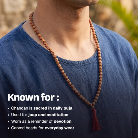 Man wearing the Chandan Carved Bead Mala over a blue cotton t-shirt