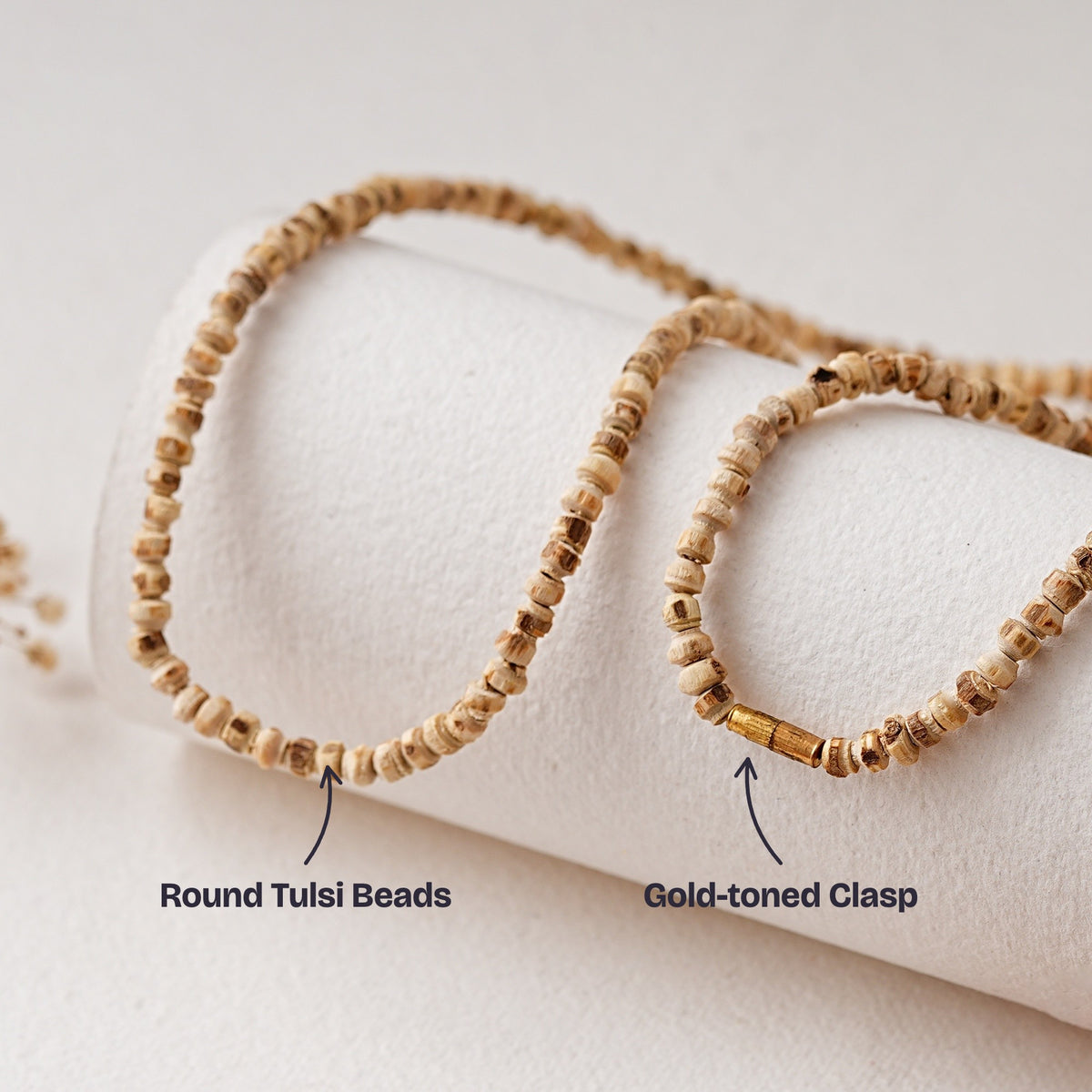 Close-up of the round Tulsi beads and the gold-toned clasp