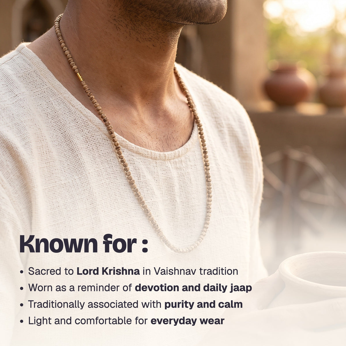 Man wearing the Tulsi Kanthi Mala over a cream kurta